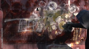 Homeless man spray painting old train wagon with aerosol can