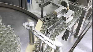 close up of empty glass vial bottles moving on a conveyor belt in two rows. medical Injection making process ampoules in a pharmaceutical manufacturing production medicine factory