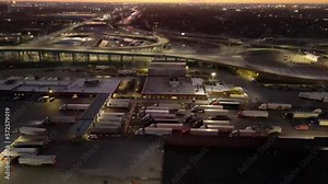 Trucks Crossing The Iconic Ambassador Bridge At Night, Border Of US And Canada In Detroit, Michigan. aerial sideways