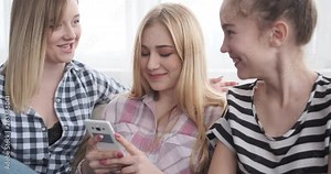 Teenage girls watching media content and dancing