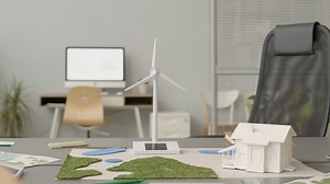 Free stock video - Wind turbine miniature and house model on office table 1
