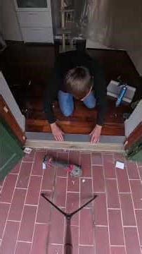 A man installing a window and a door threshold.