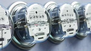 Electric meters in a row measuring power use. Electricity consumption concept. Looped 3d animation