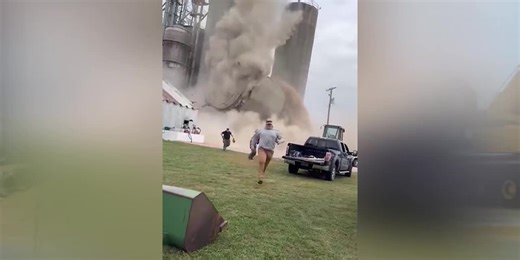 Grain silo collapses on camera, sending nearby firefighters running for safety