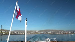 Faroese Flag On Smyril Ferry Leaving Torshavn City In Faroe Islands. - wide