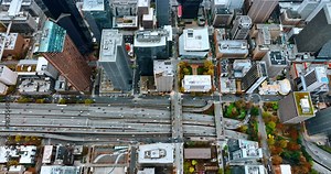 Transport moving by the multi-lane highways and freeways in the downtown of Seattle, Washington State, the USA. Densely built cityscape of the modern city from top.