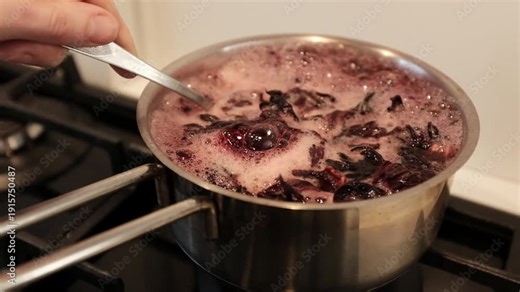 Close up of dyeing Easter eggs using natural hibiscus tea to create a deep blue marbled texture, eco-friendly DIY holiday traditions. Dyeing eggs with hibiscus creates stunning, natural shades.