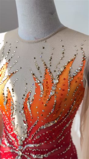 Kaitlyn Wilson on Instagram: "A fire dress for a fiery skater🔥 Red, orange, gold, and yellow airbrushed and handpainted flames, cut outs, a flamey neckline, piece-y mesh skirt, and lots of gold crystals make up a bold and edgy costume for K’s Firebird program. Wishing you all the best at your very first JGP this season💕 ✨If you’re looking for a beautiful costume of your own this upcoming season, please send me an email (no DMs please) using the email button in my bio to inquire about availabil