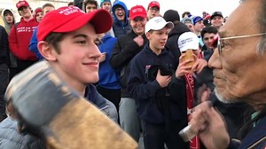 High school students in MAGA hats mock native American during rally