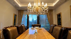 Elegant Dining Room Setting With Chandelier and Large Table at Sunset