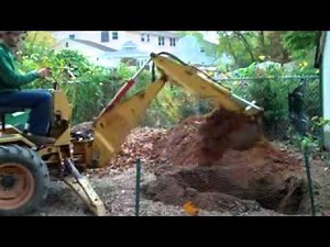 Ingersoll 6018 loader backhoe digging a hole