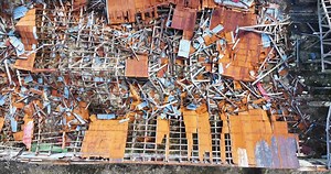 Remote Iceland farm, in various stages of decay, features a collapsed roof, scattered debris, and a serene lake in the distance, demonstrating nature's reclaiming power.