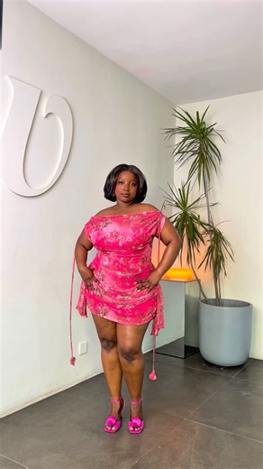 Bawsty on Instagram: "SOLD OUT in Pink Sunflower and Cherry Blossom & Fuchsia Field! This elegant mini dress offers three beautiful looks in one! Wear its convertible neckline as a high cowl, asymmetrical, or off-shoulder. Its flattering drape details at the hips complete its effortlessly chic design. Price: 36,000 NGN, 51.43 USD Model 1 is 5’5” She wears a UK 20 and a Bawsty Large. She is wearing a bra and high-waist tights. Model 2 is 5’7” She wears a UK 12 and a Bawsty Medium. She is wearing