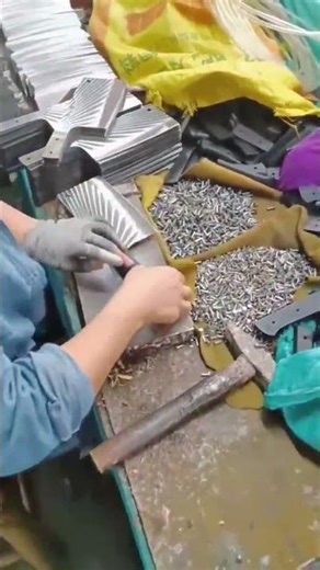 assembling metal handles on sharp meat cleavers using small silver pins #shorts