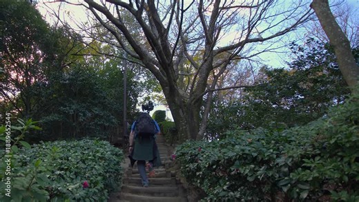 Photographer with backpack and large camera on monopod over shoulder