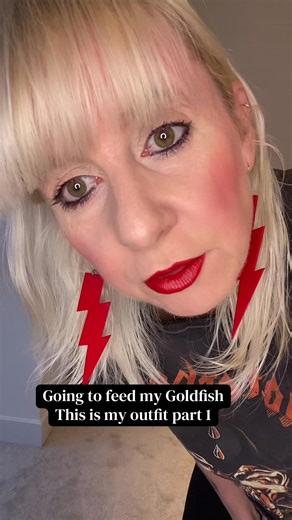 Going to feed my Goldfish This is my outfit part 1 Motörhead orange and black band tshirt, black rock snack skin print leggings red large lightning bolt earrings, doc Martin boots. #EverydayRebellion #motörhead #heavymetalgirl #punkgirls #altfashionstyle