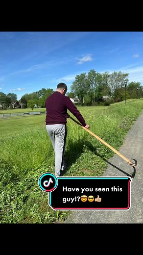 Guy using a scythe to cut grass 🤯#scythe #scythe_clean #scythemoment #cuttinggrass #grass #fyp #like #viral #havefun #life #good #sunnydayvibes #biketrail #park #man #homestead