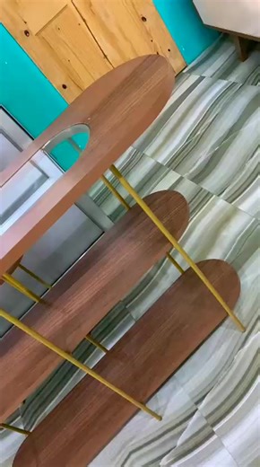 Modern console table with a sleek and minimalist design,perfect for a contemporary interior. ✨️ ✅️The tabletop appears to have a wood-grain finish, giving it a warm, natural touch. ✅️The body and lower shelf are white, providing a clean and contemporary contrast to the wood top. ✅️The legs are thin and metallic, likely with a gold or brass finish, adding a bit of elegance and sophistication. Aparador Infinity Glass top $44,500 Aparador vivant $53500 Shop 401 ! Shop Quality ! Shop Smart ! Visit u