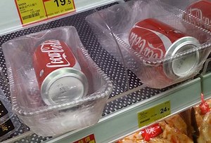 Coke cans inexplicably individually wrapped and sealed in containers at Central store | Coconuts