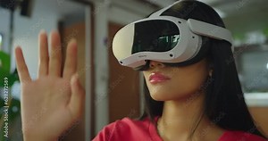 Beautiful asian woman relaxing and playing VR goggles and using futuristic tablet at home. the concept of metaverse, versual reality, future, technology, and internet of things.