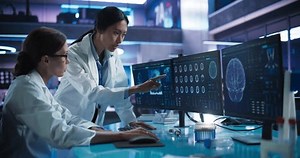 clip-1110879651-asian-caucasian-female-doctors-talking-medical-research