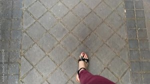 young girl walking down the street wearing sandals Stock Video