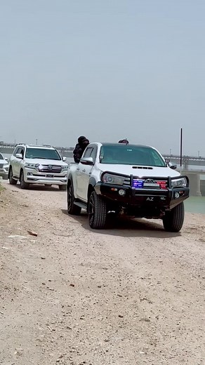Toyota Pickup Truck Driving Near Scenic Reservoir