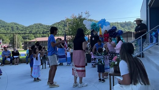 New Kituwah Academy students perform the Bear Dance at the ribbon cutting ceremony of the new Cherokee Youth Center on the morning of Friday, July 15. (JONAH LOSSIAH/One Feather Video) | Cherokee One Feather