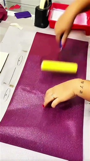 Creative hands pressing paper with precise care