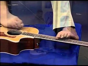 Man without arms playing guitar with feet