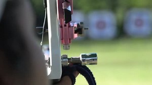 Aiming and shooting during archery target practice, close up slow motion shot