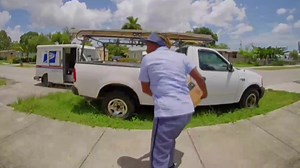 Florida postal worker caught on camera throwing package over fence