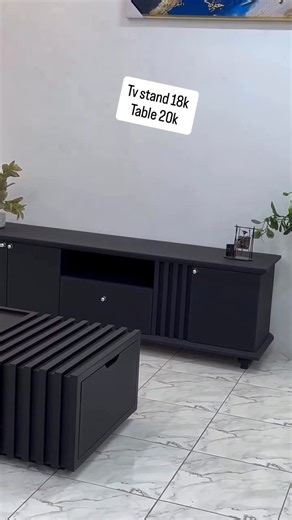 Bach furniture on Instagram: "This modern coffee table features a bold, contemporary design with clean lines and a matte black finish. The unique slatted detailing on the sides adds a stylish architectural look, making it a perfect statement piece for modern living rooms. Sturdy and well-balanced, it offers a smooth top surface ideal for décor, trays, or everyday use while complementing minimalist and luxury interiors. The TV stand showcases a sleek and elegant modern design finished in matte bl