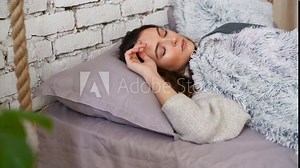 Young beautiful woman sleeping in her bed