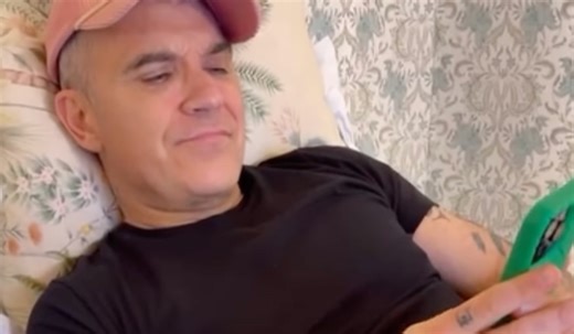 Watch: Robbie Williams calls Take That superfan from bed