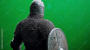 Medieval knight in chainmail with shield on green screen for easy background swap. Ideal for history, fantasy, or filmmaking projects