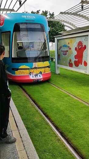 Colourful Tram at Canton, China. Tracks laid in nicely mowed grass