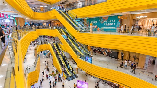 Bright yellow mall levels create a modern shopping atmosphere