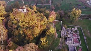Ruins of world war fortification building in countryside with beautiful nature color landscape. Italy old building ruins in the middle of hills. Drone cinematic video over italian ruins in spring.