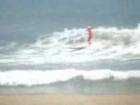 Fly away. Roy Stewart surfing a longboard with tunnel fin