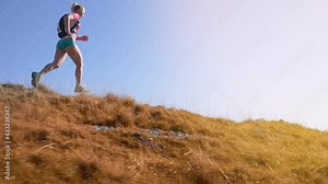 An ultra-marathon runner running downhill in slow motion