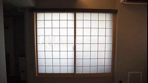 A close-up of a traditional Japanese window in Kyoto, showcasing intricate design and craftsmanship, offering a peaceful view into Japan's rich architectural heritage.