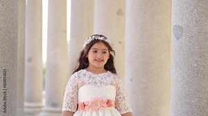First Communion beautiful girl wearing white dress walking under colonnade 1.MOV