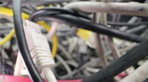 The camera enters the thicket of network cables and other disruptions. Tangled wires and computer troubles generate chaos on the screen.