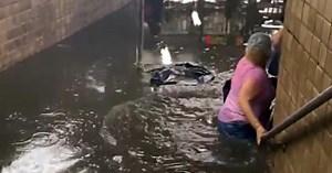 Videos show commuters wading through flooded subways in New York City