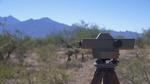 A land surveyor sighting through a transit