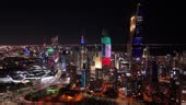 Kuwait City Night Skyline with Vibrant Tower Lights - Aerial 4K...