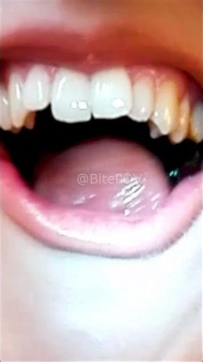 Girl with sharp teeth bites a licorice stick… listen