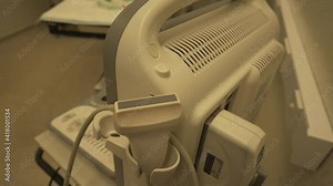 Close view of expensive ultrasound linear probe and machine in hospital setting for diagnostic imaging procedures