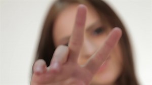 Download Cute teen girl showing peace gesture for free